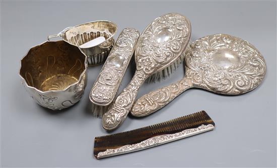 A silver half-fluted cream jug, a shaped-edge flower-embossed sugar bowl and a four-piece silver-mounted dressing table set